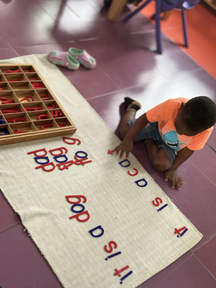 A child working with the moveable alphabet in the Children's House