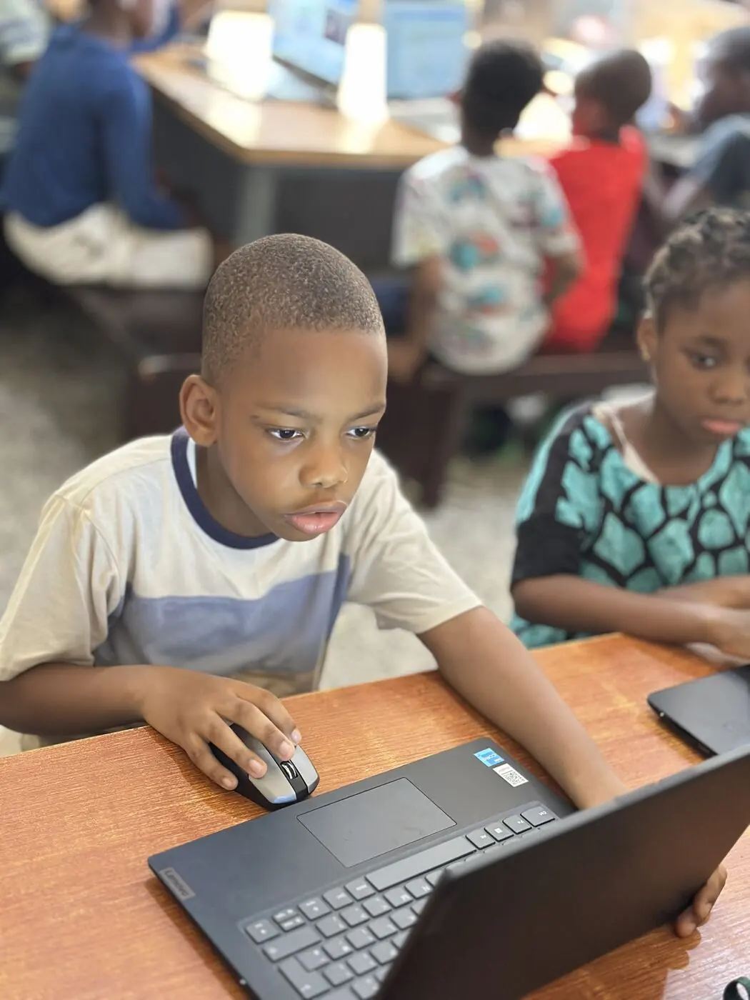A Children&rsquo;s House child working independently on a laptop