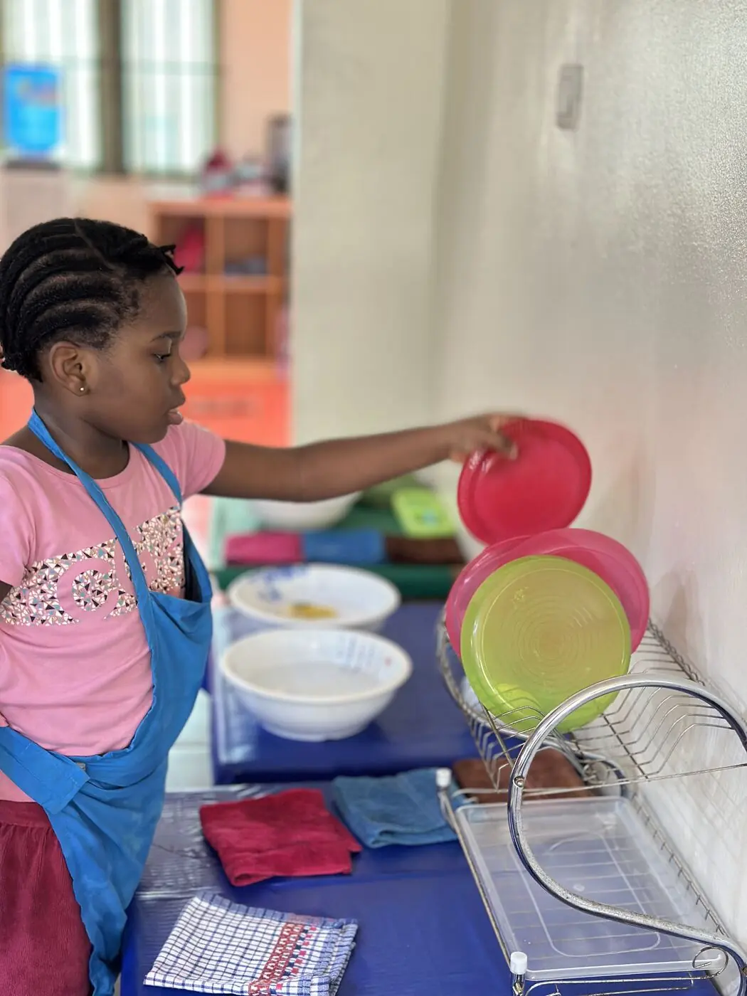 A toddler stacking dishes during a practical life activity