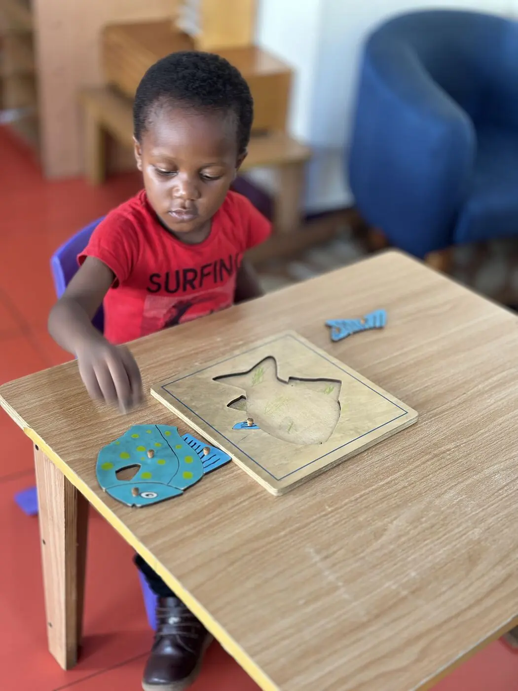 A Toddler child working with a puzzle map