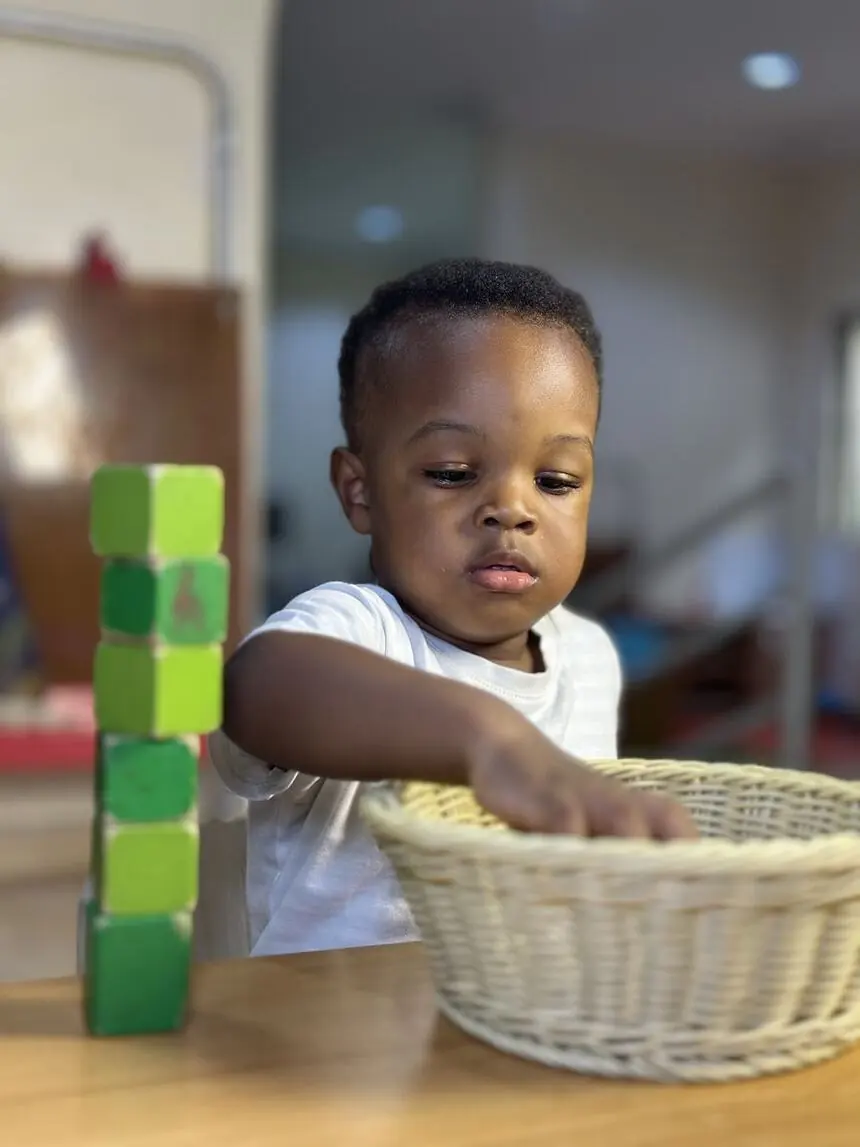A toddler exploring materials in the Nido Program