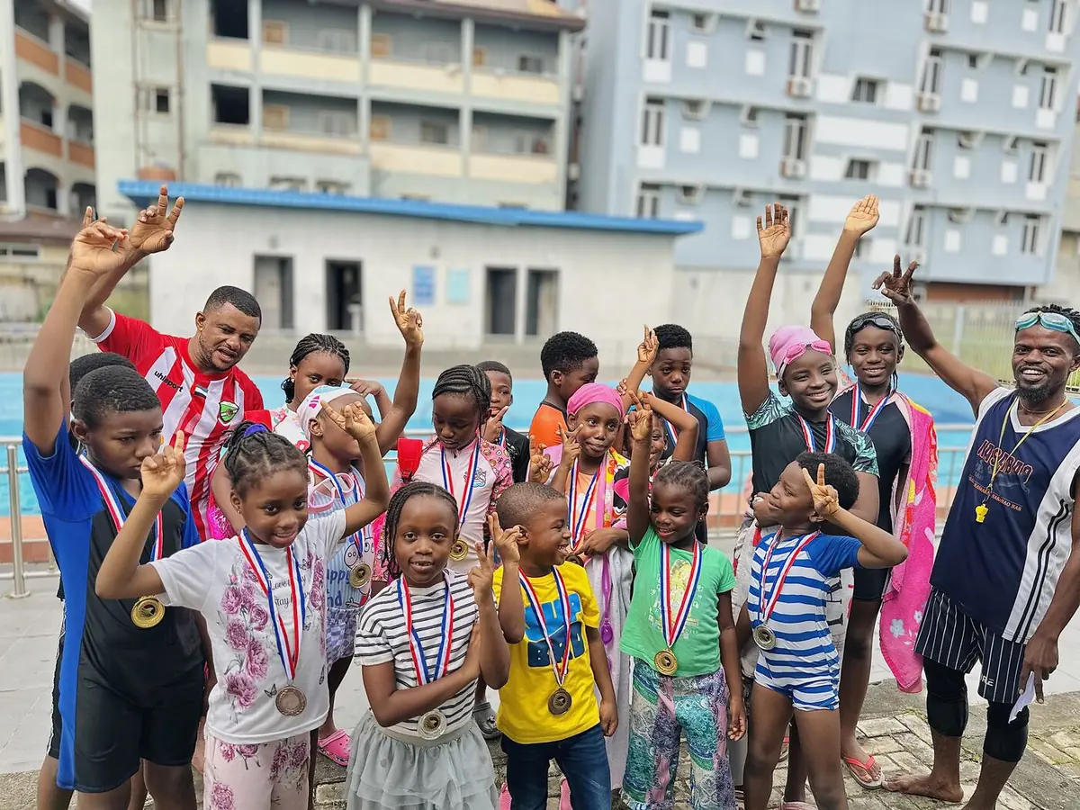 Children&rsquo;s House children celebrating with medals after a swim event