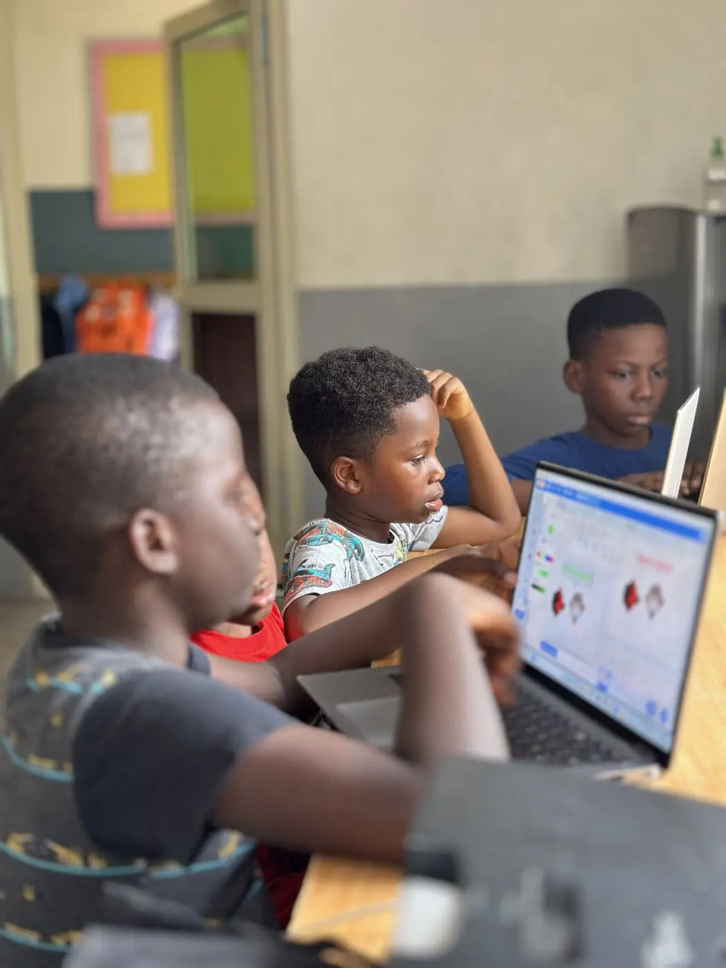Children&rsquo;s House children working with technology during class