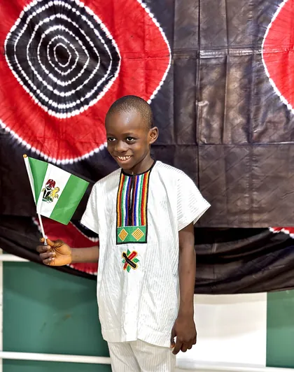 A child dressed in Nigerian colours celebrating Independence Day at Aquila Nidus