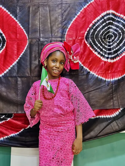 A child dressed in Nigerian colours celebrating Independence Day at Aquila Nidus