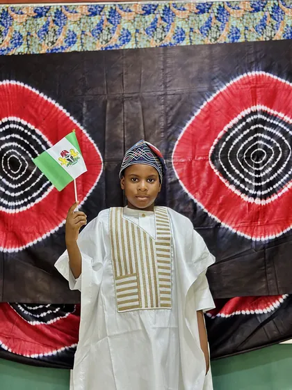 A child dressed in Nigerian colours celebrating Independence Day at Aquila Nidus